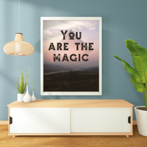 Photographic fine art poster that says, You are the Magic, over the river at sunset. Shown in context on a wall, in a living room.