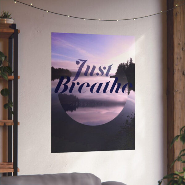 A poster of the sunset over calm water and the words that say, Just Breathe. In context, on the wall.