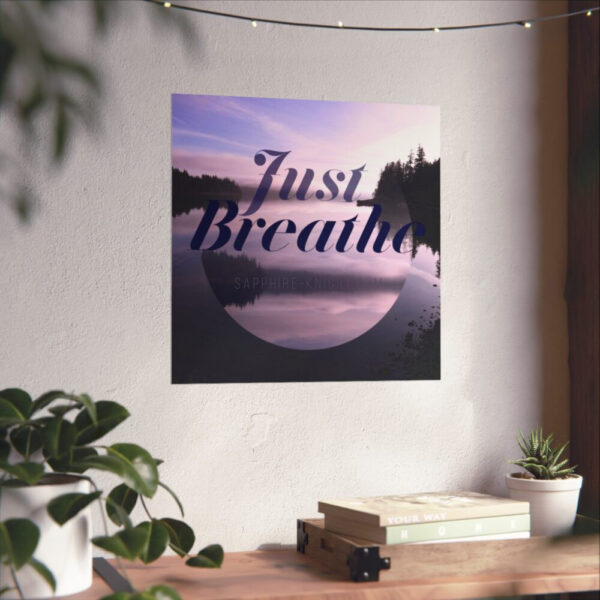 A poster of the sunset over calm water and the words that say, Just Breathe. In context, on the wall.